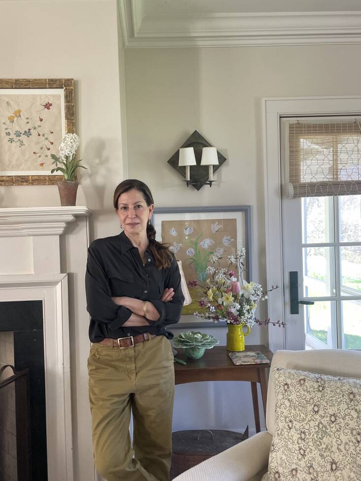 deborah, in her sitting room, surrounded by flowers, both real and human made:  28