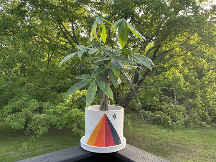 All of Michele&#8\2\17;s stoneware planters are wheel-thrown and hand-painted with extraordinary care in her Saugerties, NY, workshop. Each has a drainage hole and comes with a catch plate. This is the Prism/Crescent Yellow Planter: It has a rainbow prism and star on one side (as shown in Michele&#8\2\17;s backyard) and white crescent moon and yellow circle on the other; available in three sizes starting at \$465.