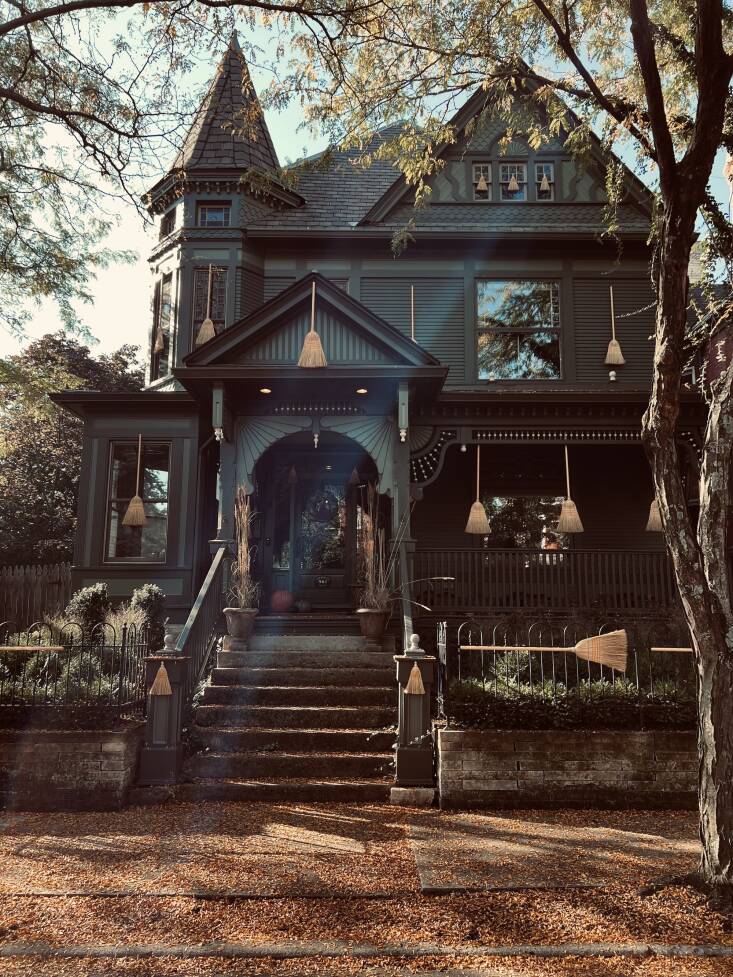 An understated seasonal display of brooms at &#8\2\16;The Witches&#8\2\17; House.&#8\2\17; On the top floor, a trio of hand brooms adorn the windows.