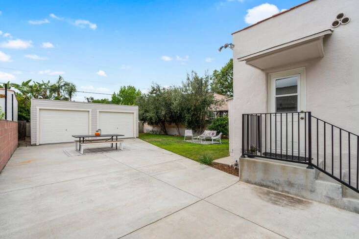 A striking difference pre-renovation shows the dominate concrete driveway.