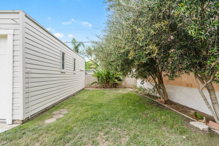 The nearly-empty side yard beside the now-studio, former garage.