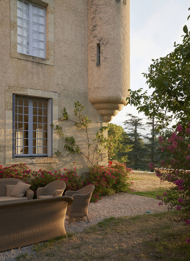 Classic wicker lounge furniture outside of the house. Photograph courtesy of L’Officine Universelle Buly from Garden Visit: A Family Vegetable Garden in Gascony, France, Inspires a New Line of Fragrances.