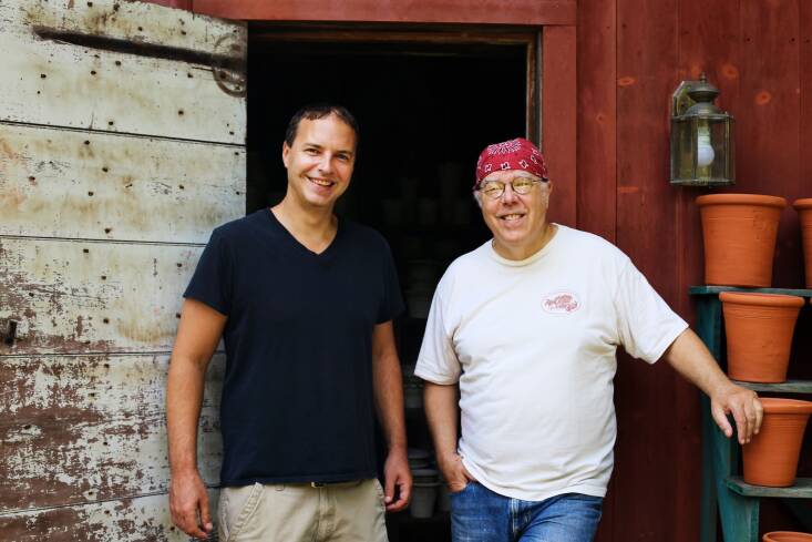 Father and son, Ben Wolff (left) and Guy Wolff (right), stand outside their shop.