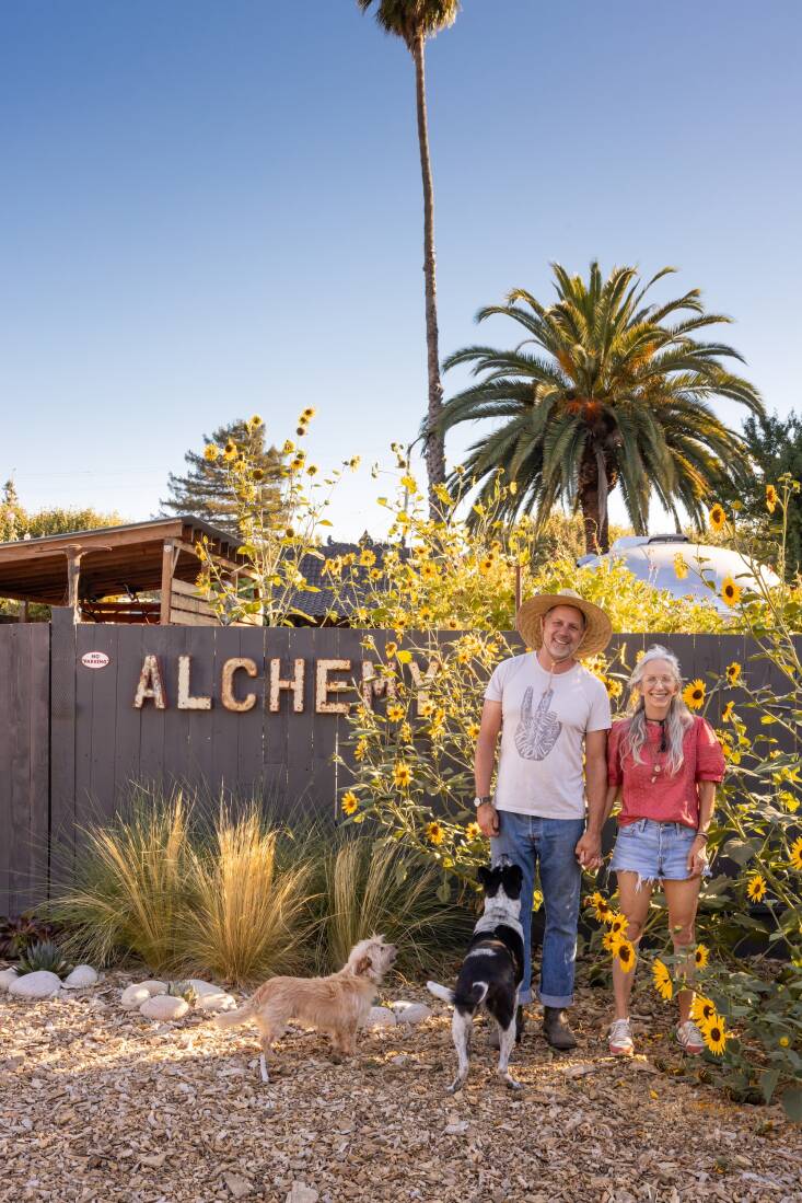 Lawrence, Stephanie, and their rescue dogs, Stan Lee (smuggled in from Bali) and Chicqui, in front of Alchemy. Their actual home is a block away.