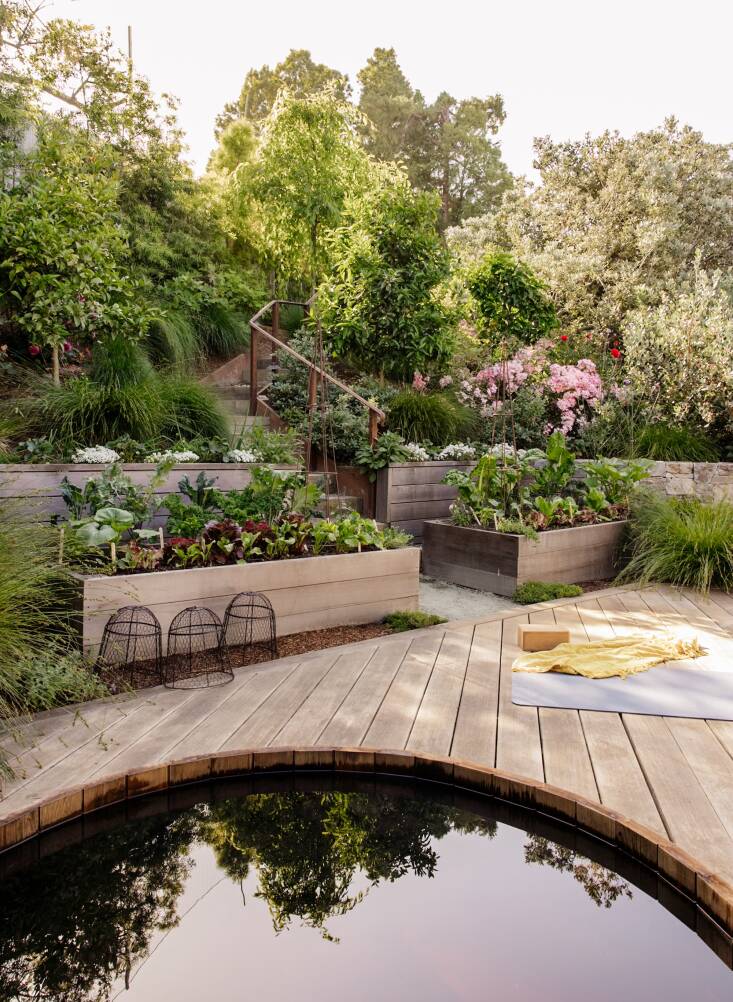 This deck with a cedar hot tub surrounded by raised beds proves that relaxation and food production can happily co-exist.