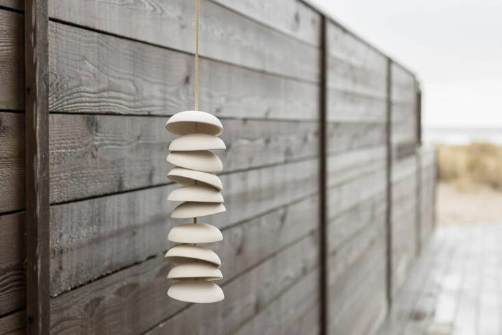 The Porcelain Wind Chime from Pigeon Toe Ceramics in Portland, Oregon, is made from a series of ceramic disks strung together on a deerskin lace cord. Shown in a natural glaze for $99 at Schoolhouse.